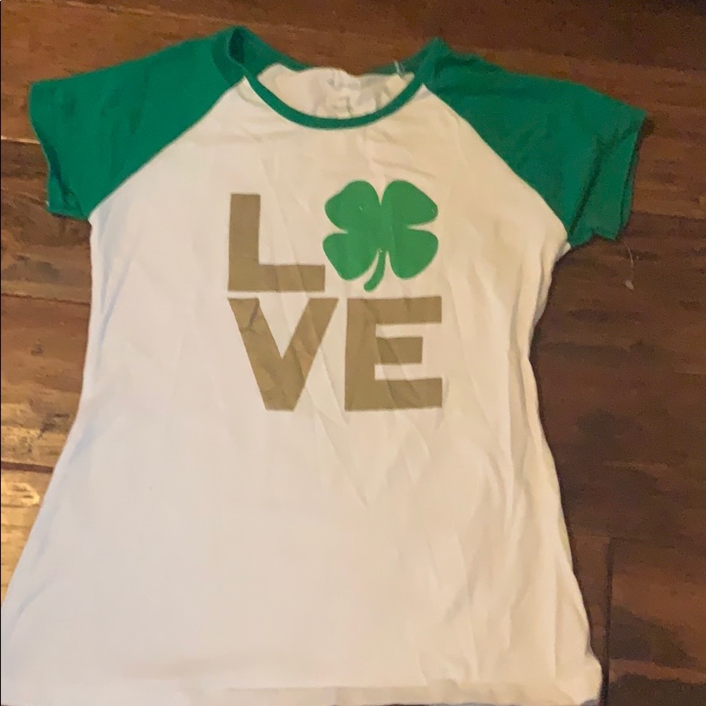 It is a green, white and gold short sleeved tee